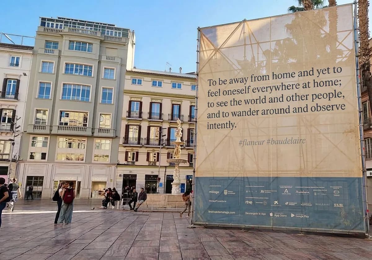 A sign at Plaza de la Constitución reading "To be away from home and yet to feel oneself everywhere at home; to see the world and other people, and to wander around and observe intently."