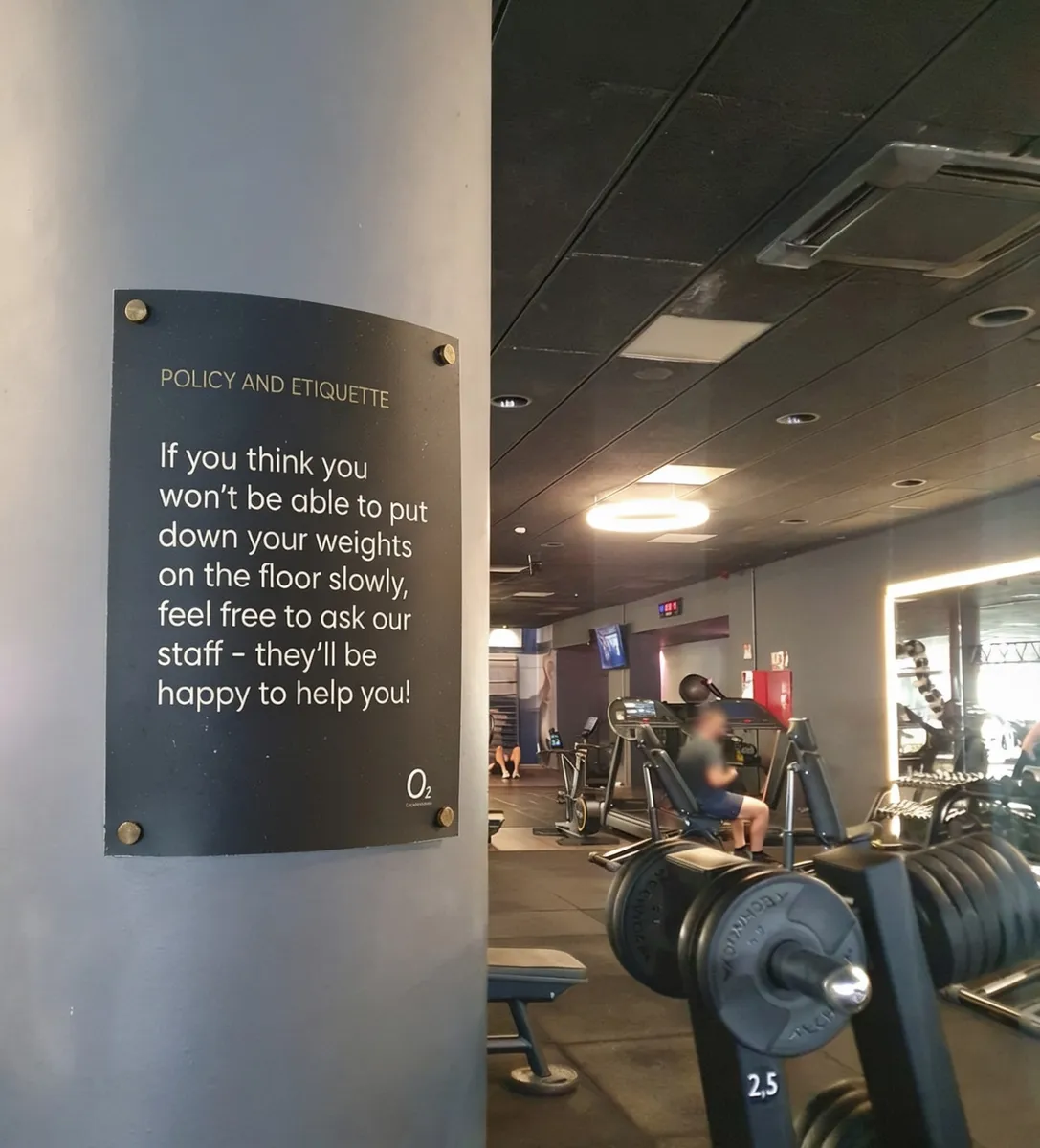 A sign on the window of Gimnasio O2 in Málaga reading "if you think you won't be able to put your weights down on the floor slowly, feel free to ask our staff, they'll be happy to help you! #juntos_podemos."